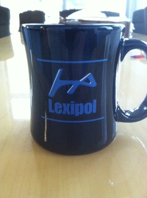 Blue Lexipol branded ceramic mug.