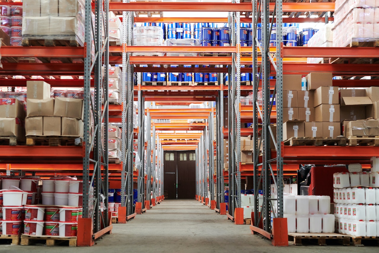 Warehouse aisle with pallets of boxes and stacked goods.